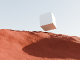 A cube floating in the sky above red dunes.